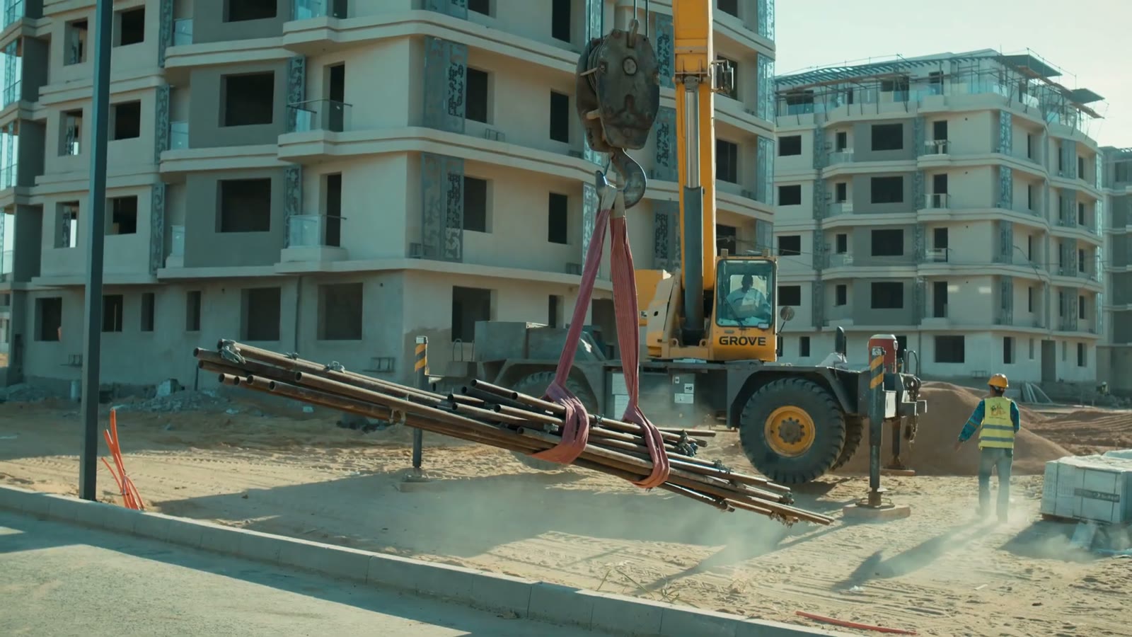 Crane lifting materials beside apartment blocks