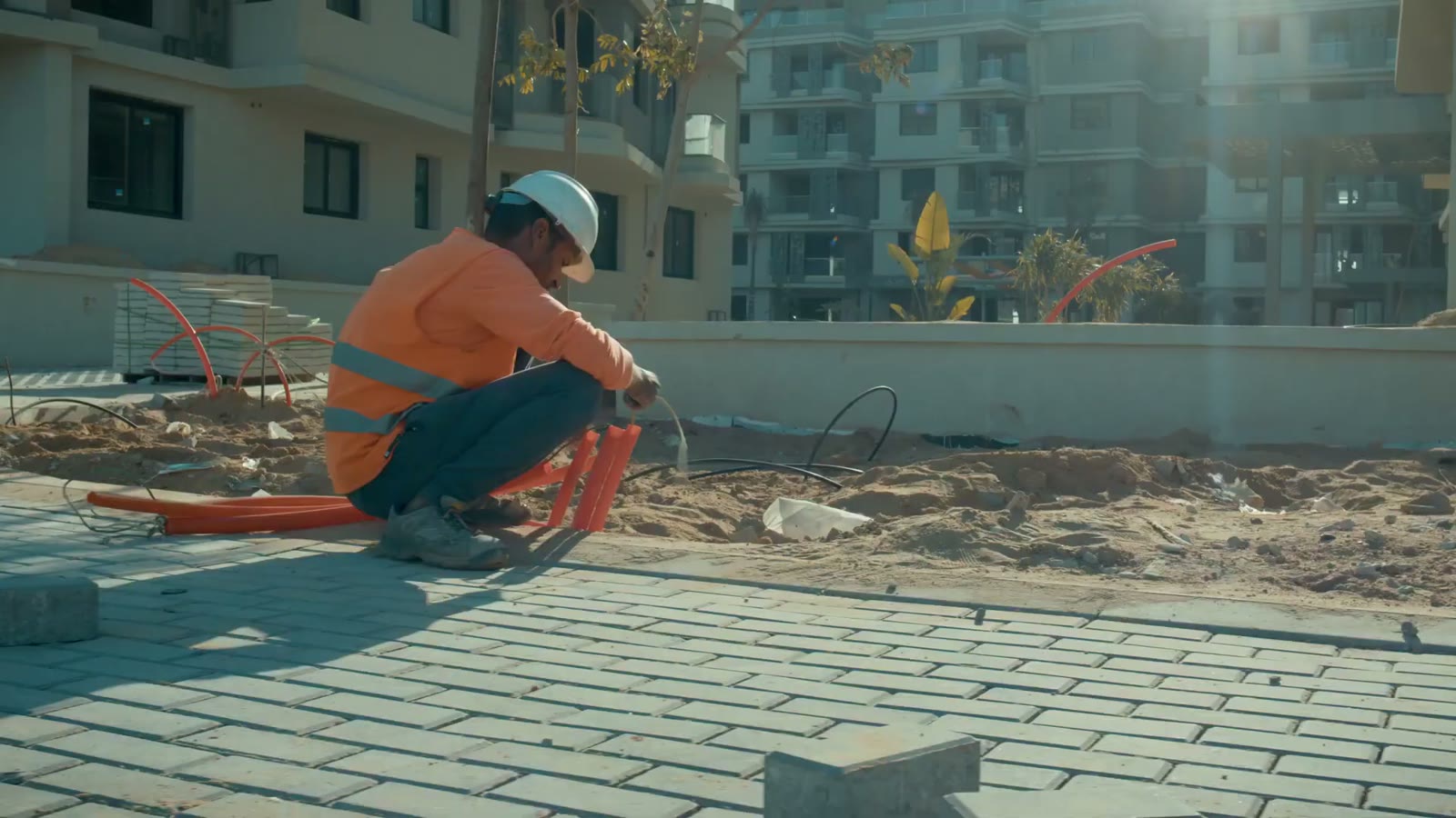 Worker laying paving stones